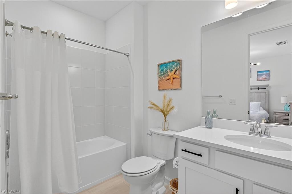 1953 Fresno Avenue Naples, FL 34120 - Photo 16 of 33 a bathroom with a sink a toilet and a bathtub