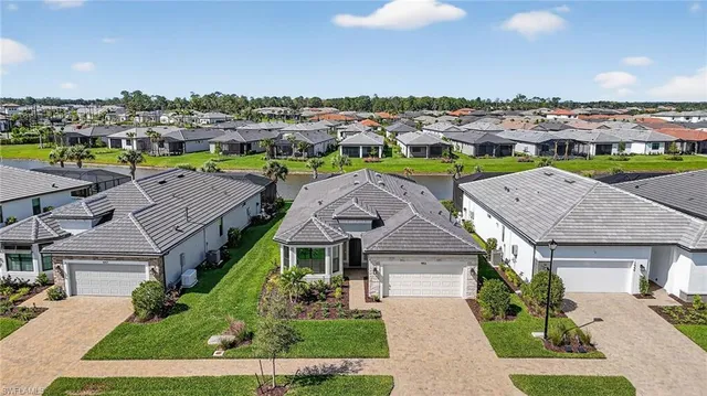 an aerial view of multiple houses with a yard