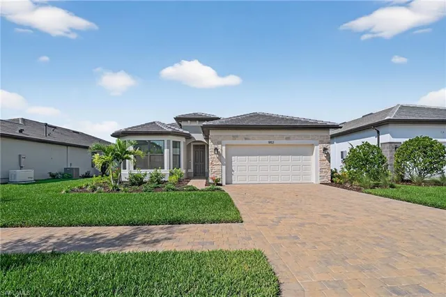 a front view of a house with a yard and garage