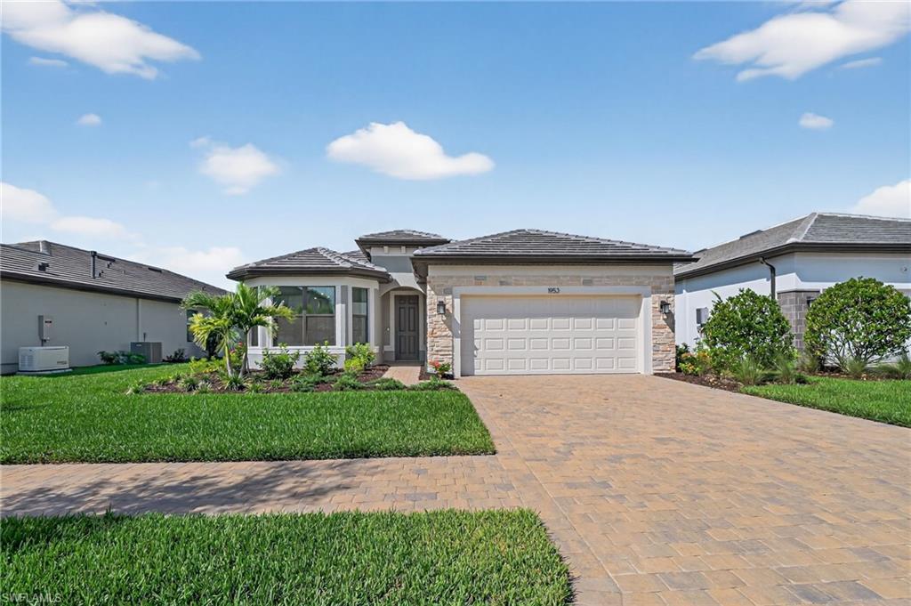 1953 Fresno Avenue Naples, FL 34120 - Photo 20 of 33 a front view of a house with a yard and garage