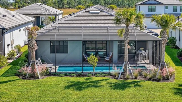 a view of a house with backyard and sitting area
