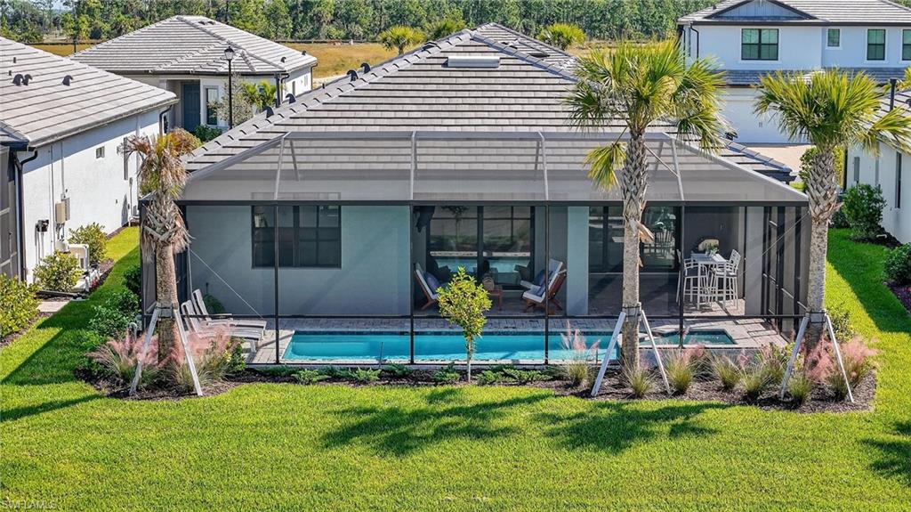 1953 Fresno Avenue Naples, FL 34120 - Photo 21 of 33 a view of a house with backyard and sitting area