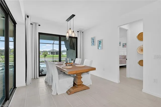 a dining room with furniture and a window