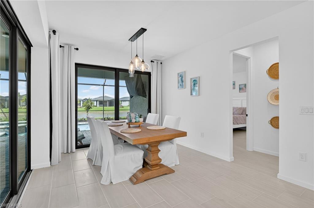 1953 Fresno Avenue Naples, FL 34120 - Photo 23 of 33 a dining room with furniture and a window