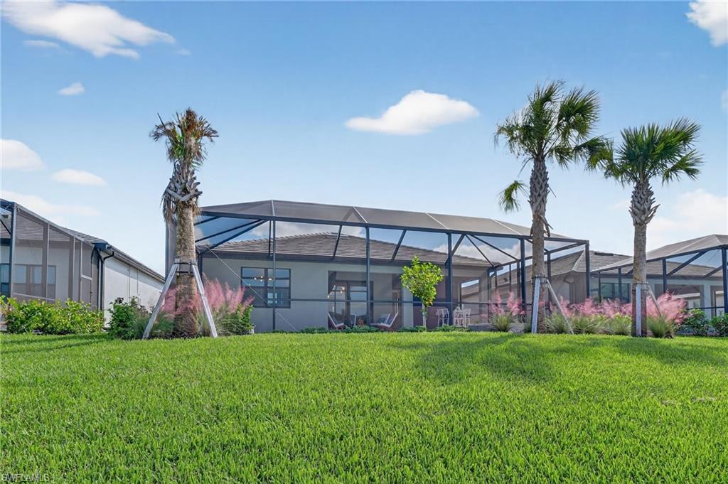 1953 Fresno Avenue Naples, FL 34120 - Photo 26 of 33 a view of a house with a yard and sitting area