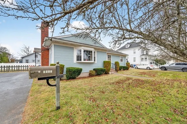 a view of backyard of the house with outdoor seating