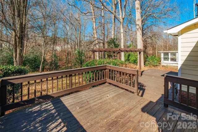 a view of a wooden deck with a yard