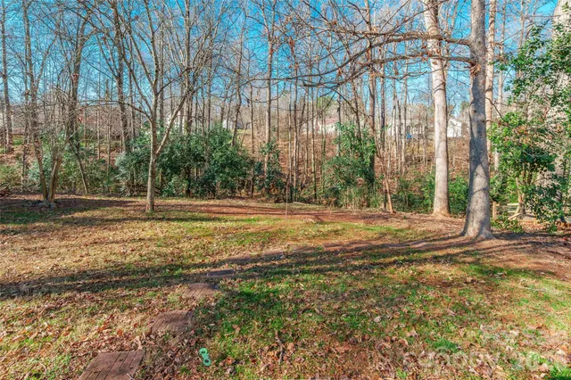 a view of a house with large trees