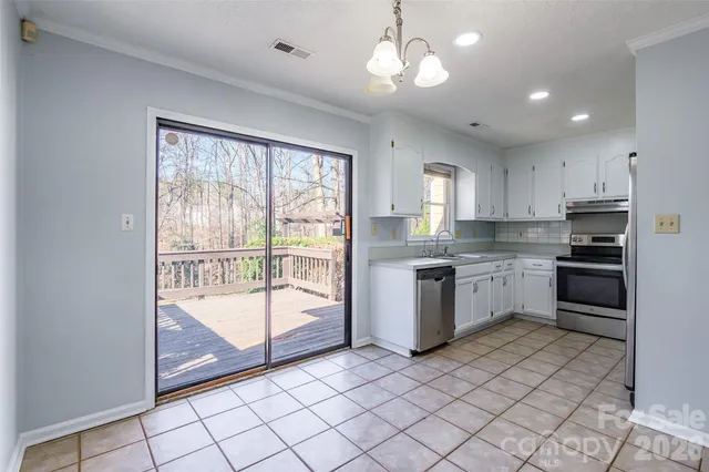 a kitchen with a refrigerator a sink and cabinets