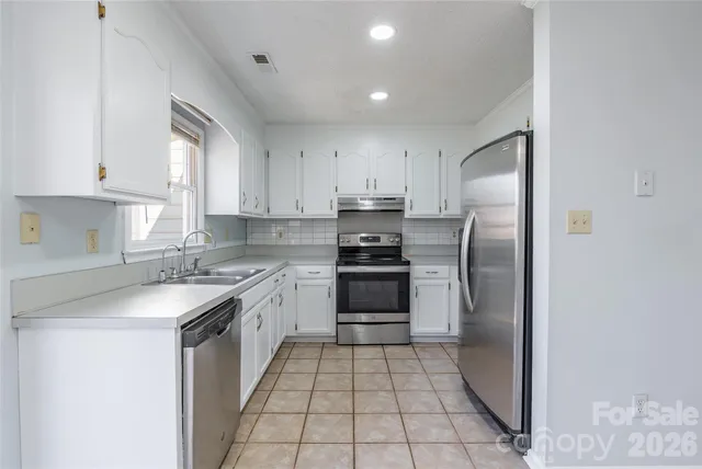 a kitchen with a sink a stove and refrigerator