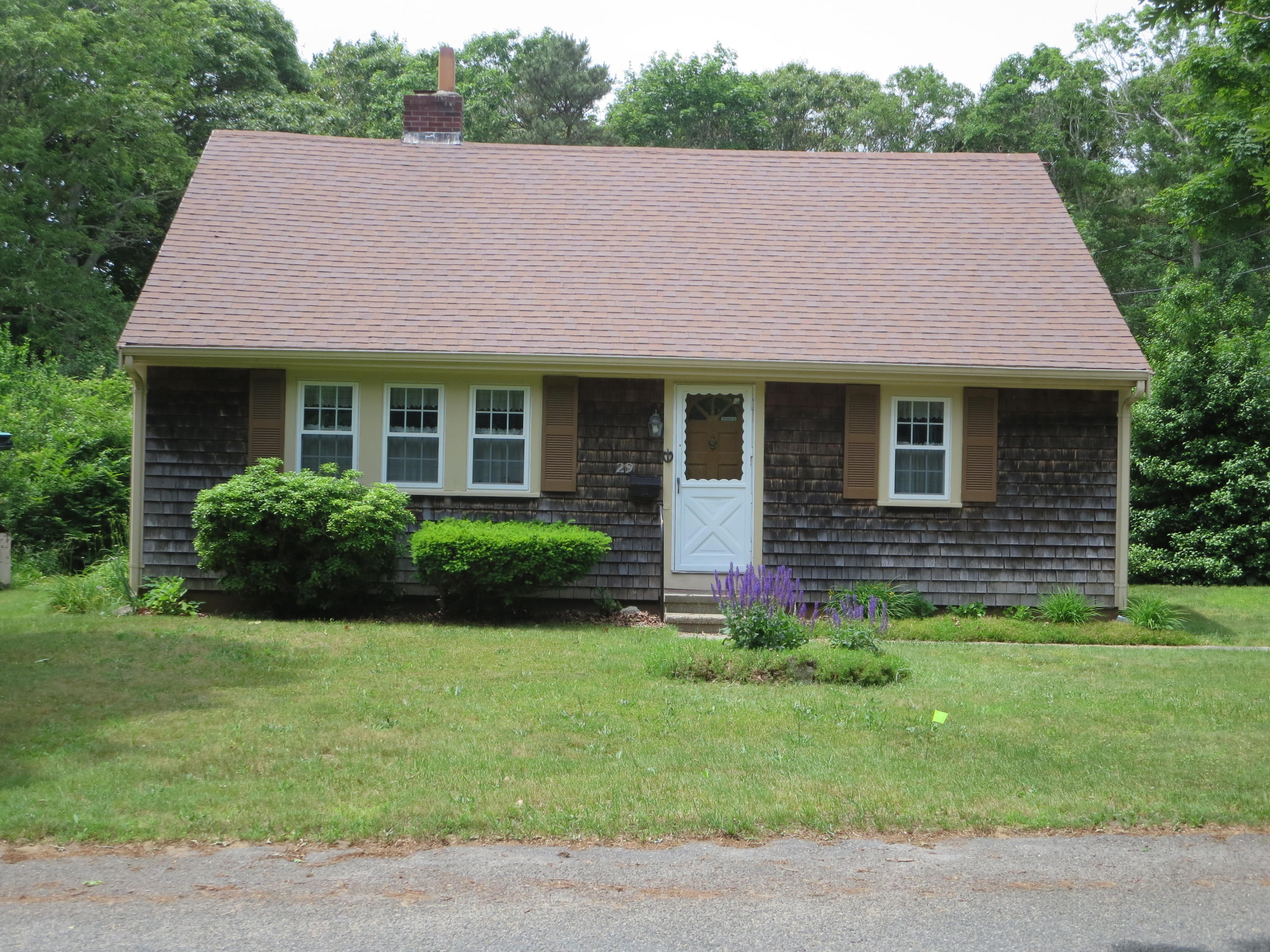 29 Kelley Road Hyannis, MA 02601 - Photo 1 of 21 a view of a house with a yard potted plants and a table