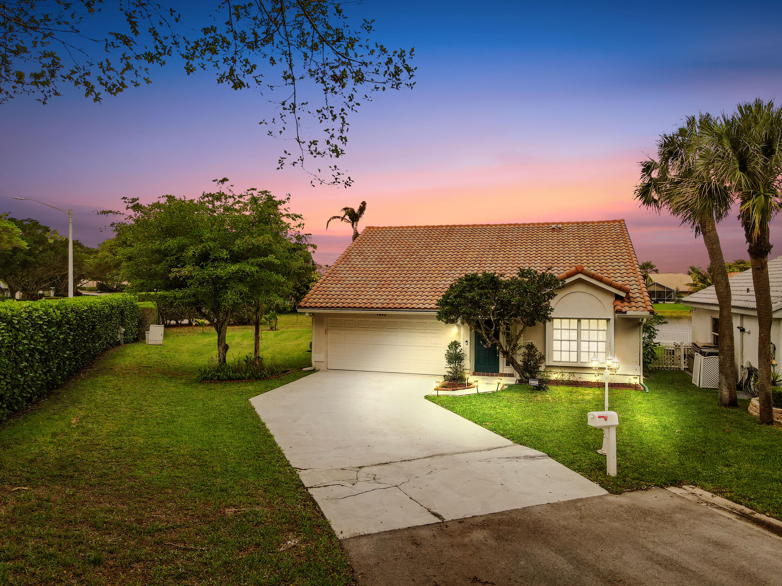 a front view of a house with a garden and yard