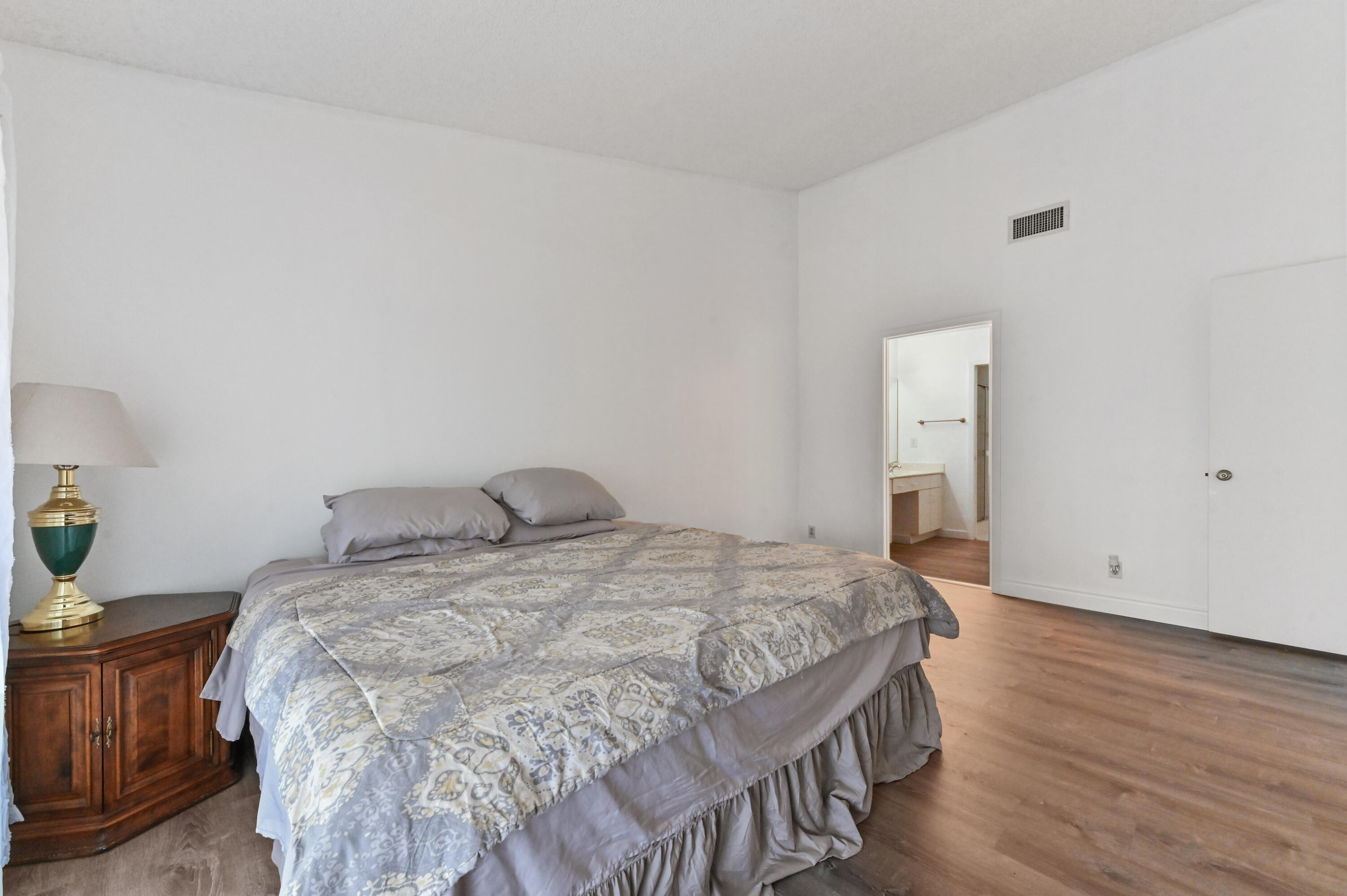 7433 Shell Ridge Terrace Lake Worth, FL 33467 - Photo 21 of 45 a bedroom with a bed and wooden floor