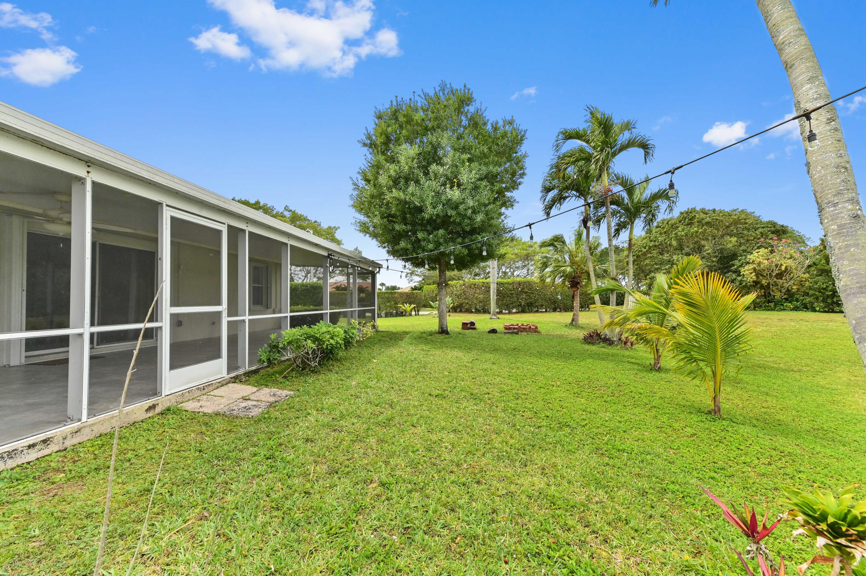 7433 Shell Ridge Terrace Lake Worth, FL 33467 - Photo 35 of 45 a view of an house with backyard space and garden