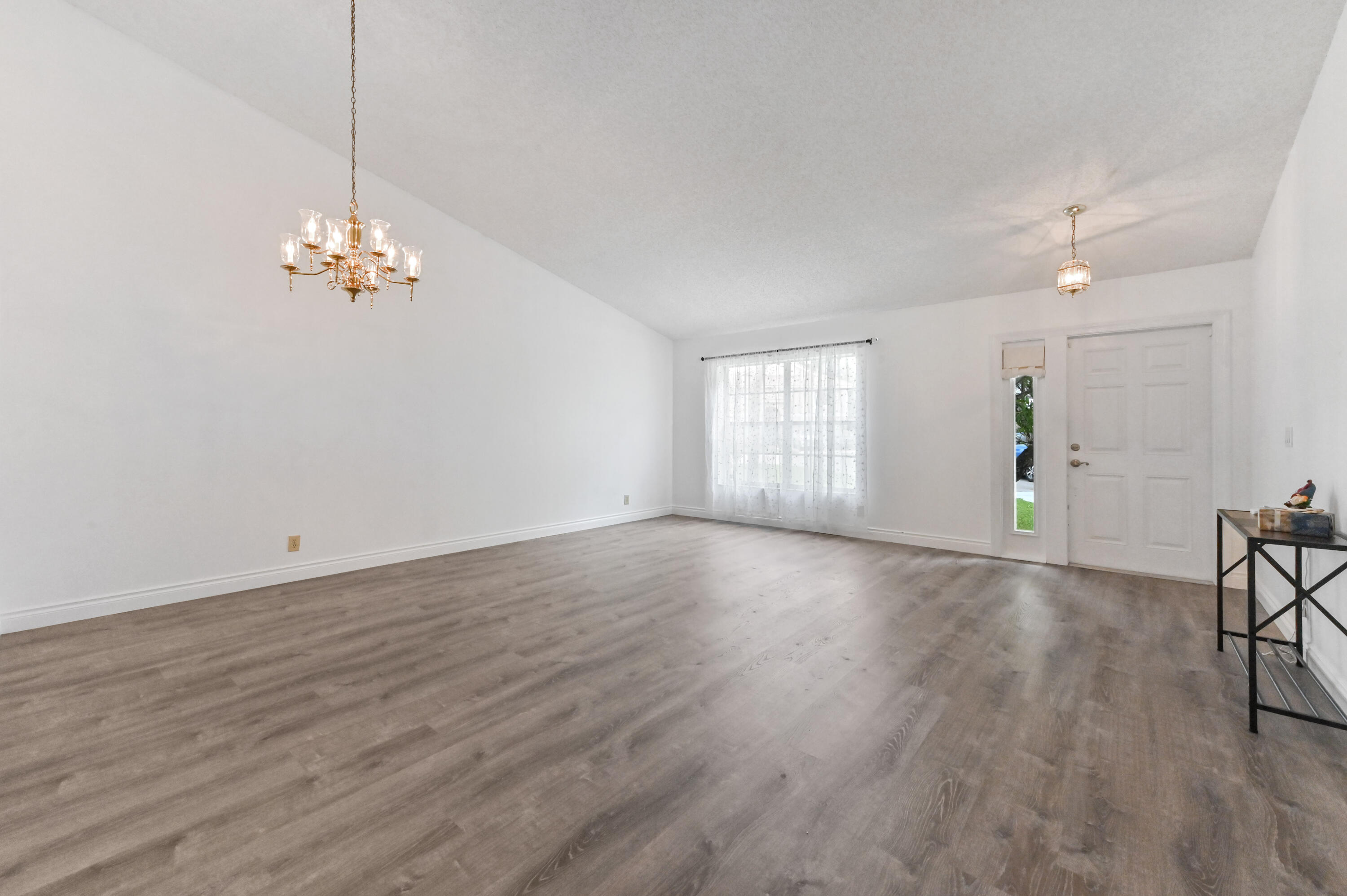 7433 Shell Ridge Terrace Lake Worth, FL 33467 - Photo 5 of 45 an empty room with wooden floor and windows