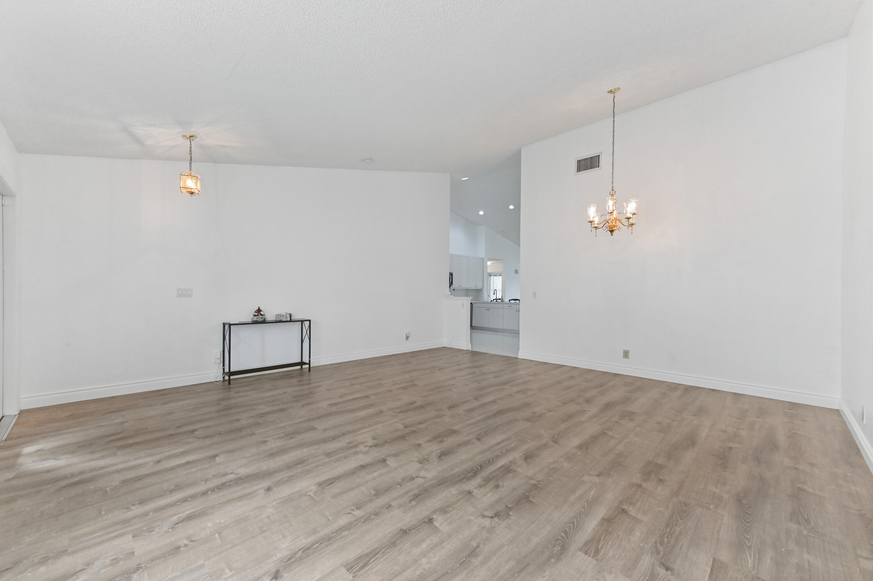 7433 Shell Ridge Terrace Lake Worth, FL 33467 - Photo 7 of 45 a view of empty room with wooden floor and ceiling fan