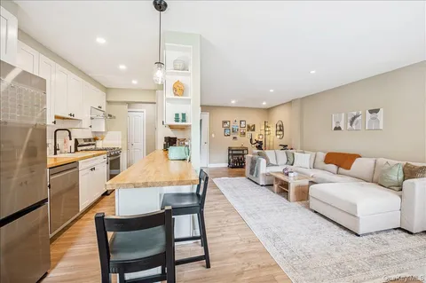 a living room with furniture kitchen and a table