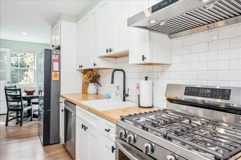 a kitchen with a stove and a white cabinets