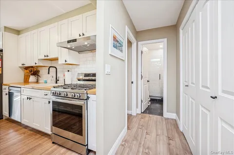 a kitchen with cabinets and wooden floor