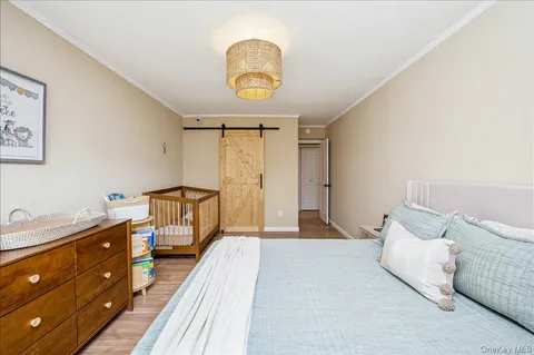 a spacious bedroom with a bed and a dresser