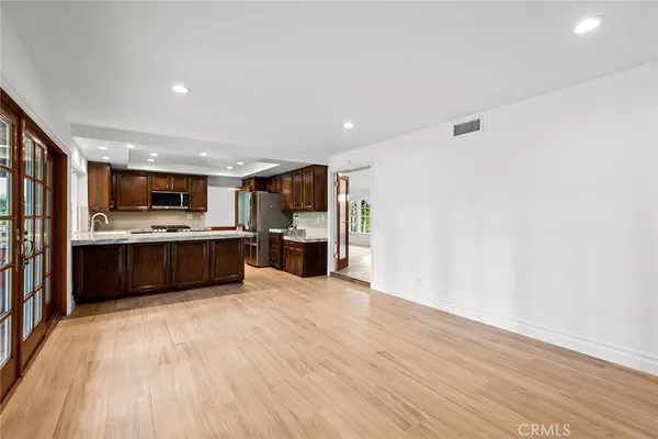 a large white kitchen with a cabinetry and kitchen view