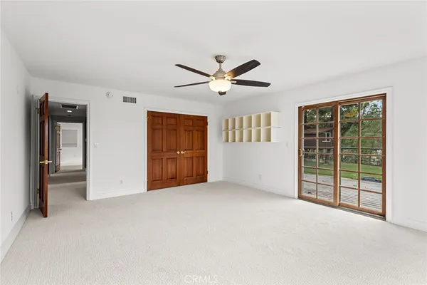 an empty room with windows and closet