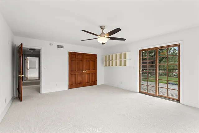 an empty room with windows and closet