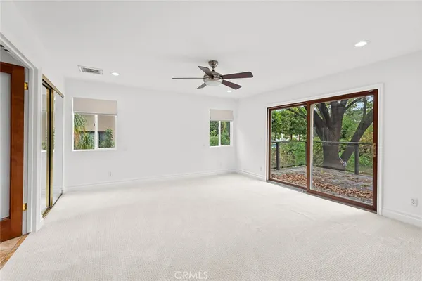 a view of a livingroom with a ceiling fan and window