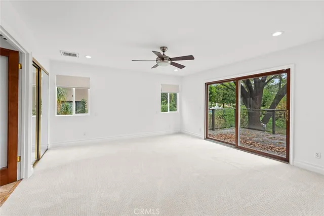 a view of a livingroom with a ceiling fan and window