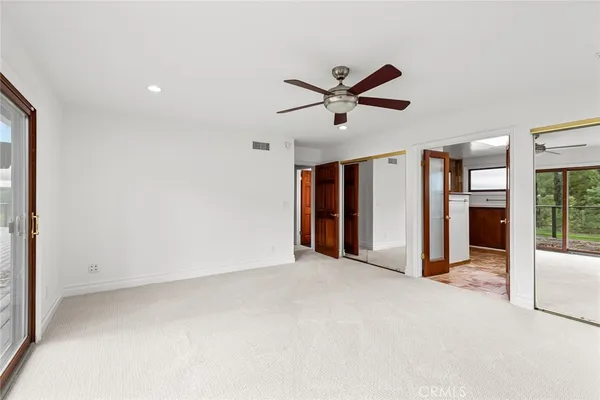 a view of a livingroom with a ceiling fan and window