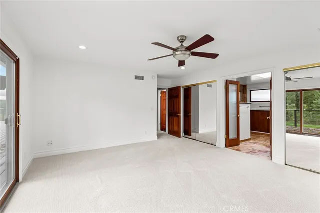 a view of a livingroom with a ceiling fan and window