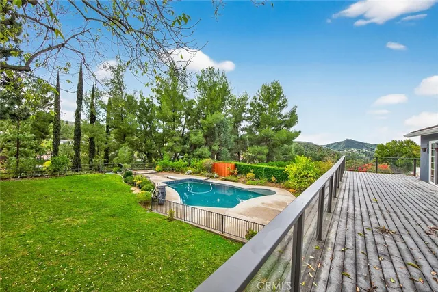 a view of a balcony with yard