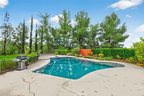 a view of a swimming pool with a patio