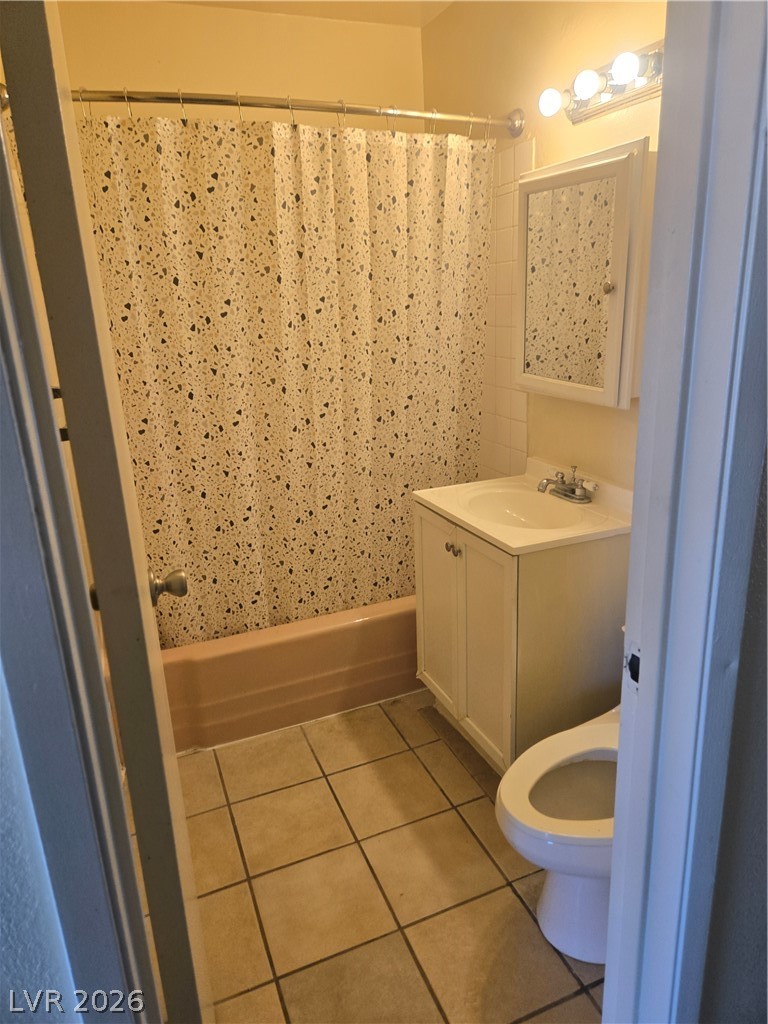 1388 East Desert Inn Road, Unit 2 Las Vegas, NV 89169 - Photo 13 of 23 Functional bathroom with a practical vanity, standard toilet, and shower-over-tub setup, providing essential amenities.