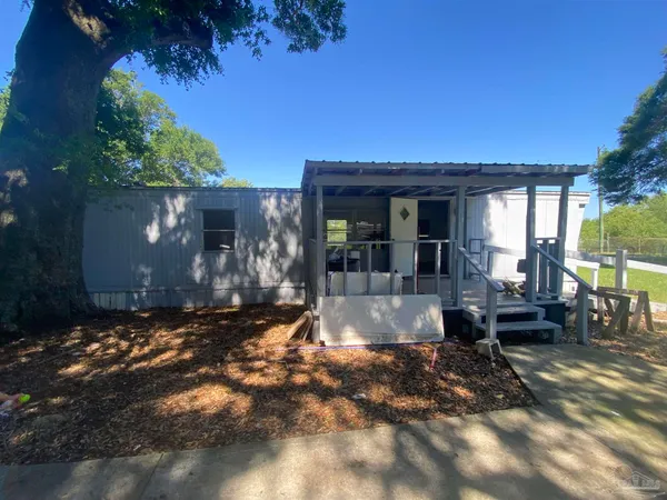 a view of a house with backyard porch and sitting area