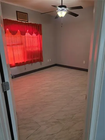 an empty room with closet and mirror