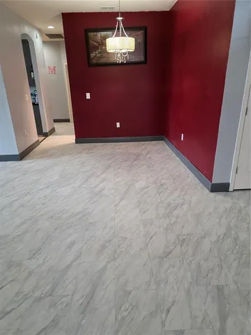 a view of an empty room with a fireplace