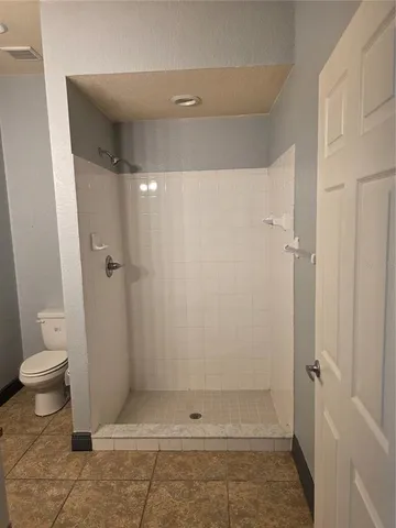 a view of an empty room with a ceiling fan