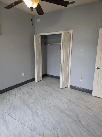 a kitchen with granite countertop a stove a sink and a refrigerator