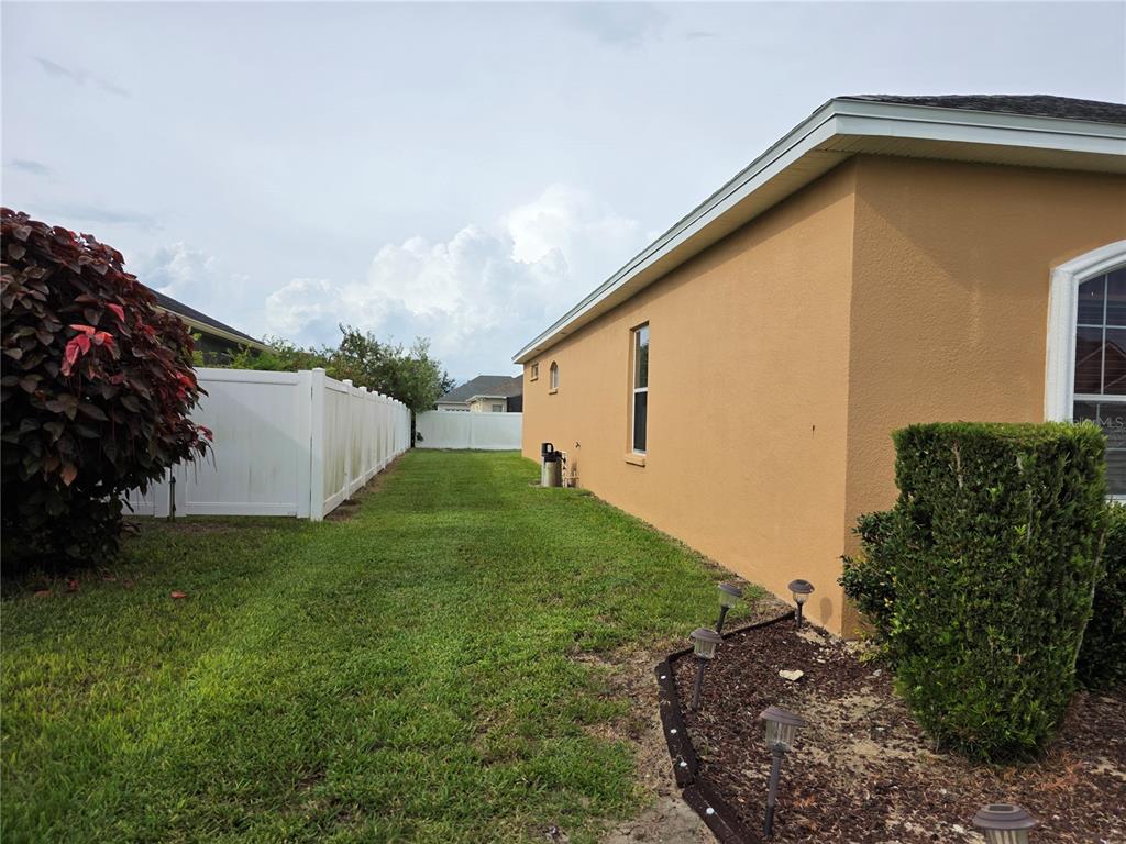 2850 Sheldon Street Lakeland, FL 33813 - Photo 4 of 59 a backyard of a house with lots of green space and plants