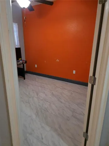 a view of an empty room and a window