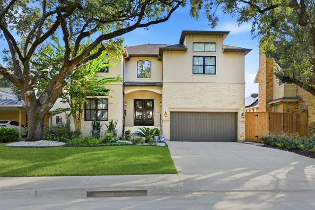 a front view of a house with a yard and a garage