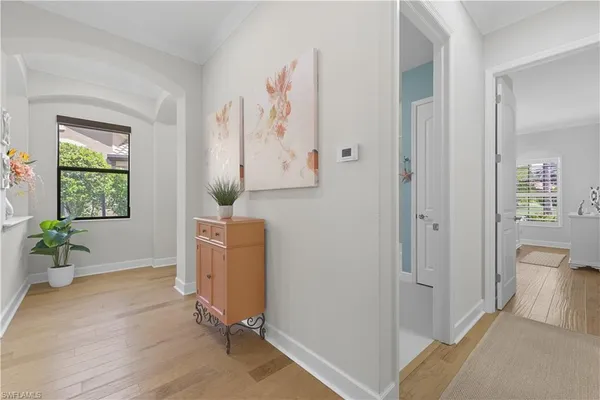 a view of a room that has a bed and a table in it