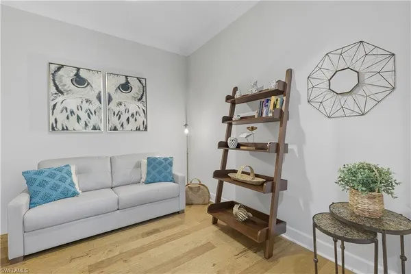 a living room with furniture and a potted plant