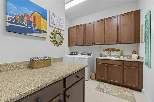 a kitchen with a sink a stove and cabinets