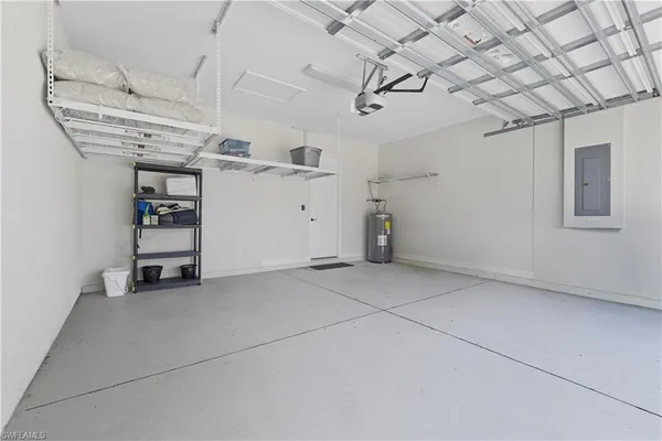 a front view of a building with swimming pool and furniture