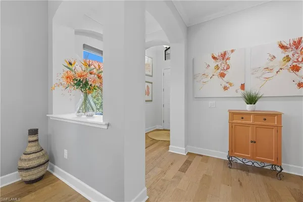 a view of a bedroom with paintings on the wall