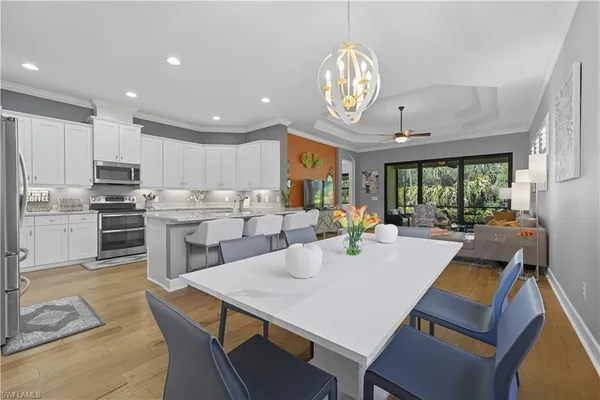 a large kitchen with a table and chairs