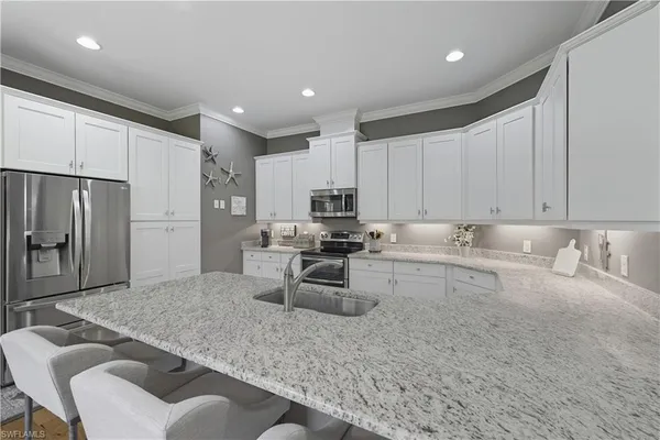 a kitchen with a refrigerator and a sink