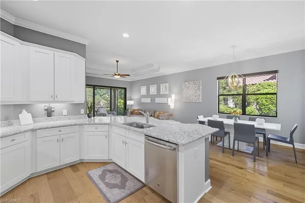 a kitchen with a stove a sink a dining table and chairs